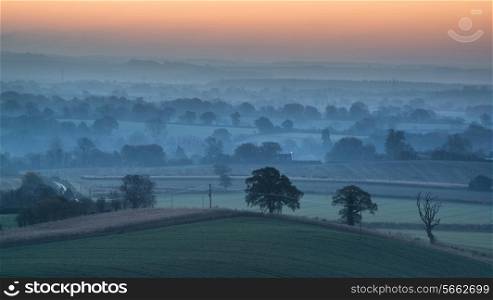 Beautiful countryside foggy sunrise landscape with layersof fog