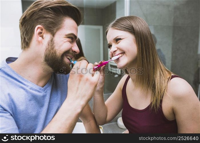 beautiful couple brushing teeth