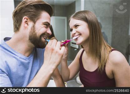 beautiful couple brushing teeth
