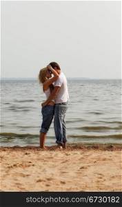 beautiful couple embrace on a beach