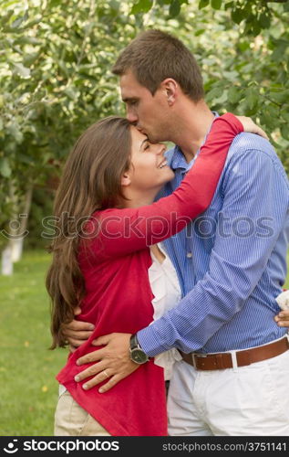 Beautiful couple enjoying in the beautiful autumn day. . Beautiful embraced couple in the park