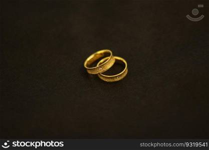 Beautiful couple gold wedding ring detail presentation.