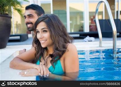 Beautiful couple having fun in swimming pool
