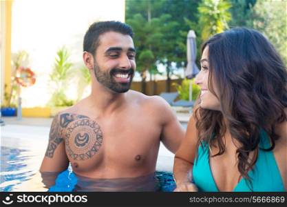 Beautiful couple having fun in swimming pool
