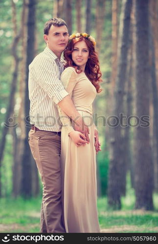 Beautiful couple holding hands in the park, first love, romantic date outdoors, sensual relationship, love and togetherness concept