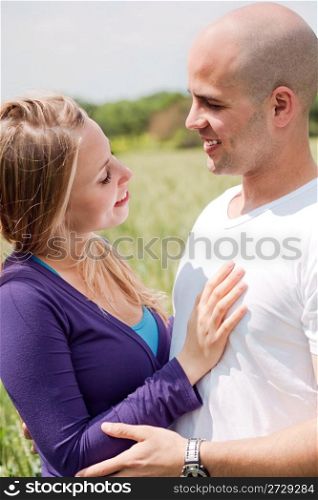 Beautiful couple in love looking at each other, outdoors