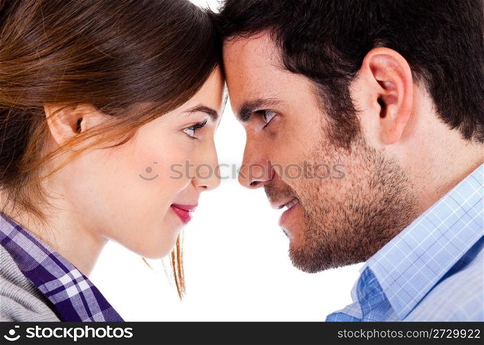Beautiful couple smiling and facing each other on a isolated white background