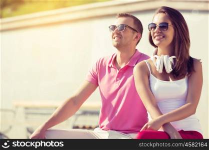 Beautiful couple spending weekend outdoors. Young happy couple having date in summer park