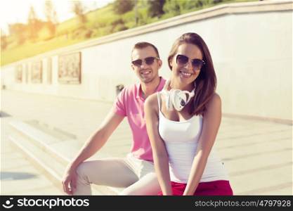 Beautiful couple spending weekend outdoors. Young happy couple having date in summer park