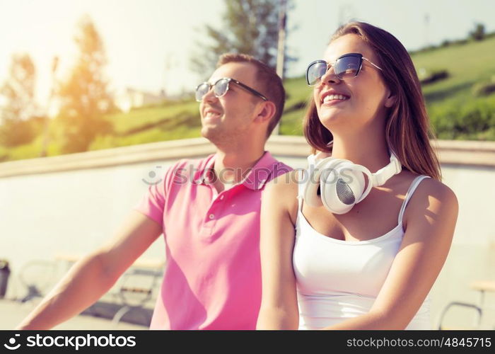 Beautiful couple spending weekend outdoors. Young happy couple having date in summer park