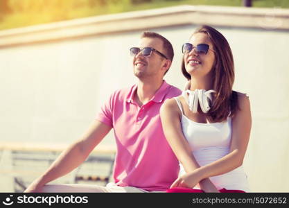 Beautiful couple spending weekend outdoors. Young happy couple having date in summer park