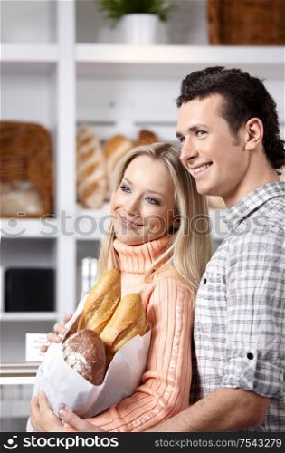 Beautiful couple with grain products on a forward background