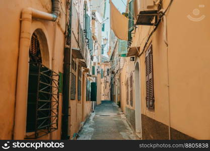 Beautiful cozy narrow street in old town of Italy or Greece. Historic european facades of buildings. Cityscape concept. High quality photo. Beautiful cozy narrow street in old town of Italy or Greece. Historic european facades of buildings. Cityscape concept.