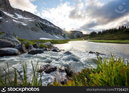 Beautiful creek in mountains at sunrise