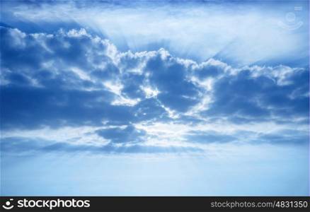 Beautiful cumulonimbus clouds, bright sun beams through fluffy cloud, sky background, overcast weather, abstract natural backdrop
