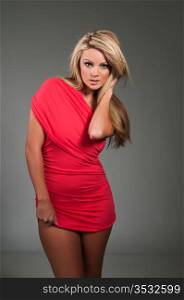 Beautiful curvy blonde dressed in a tight red dress