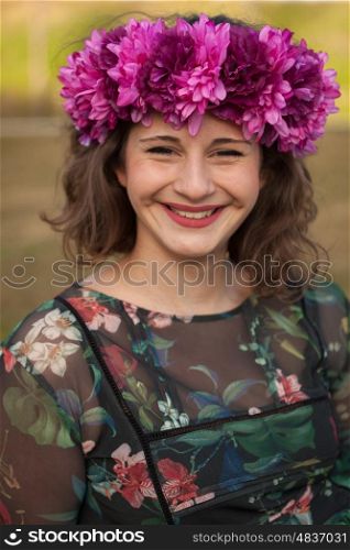 Beautiful curvy girl with a flower crown in the landscape