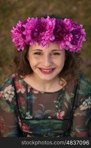 Beautiful curvy girl with a flower crown in the landscape