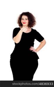 Beautiful curvy girl with black dress indicating something with the finger isolated on a white background