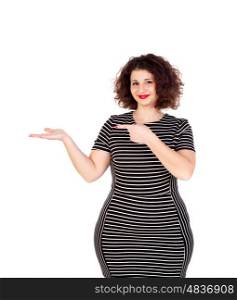 Beautiful curvy girl with striped dress indicating something with the finger isolated on a white background