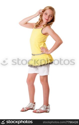 Beautiful cute blond young teenager girl wearing fashion clothes, yellow layered shirt withy white shorts and belt, isolated.