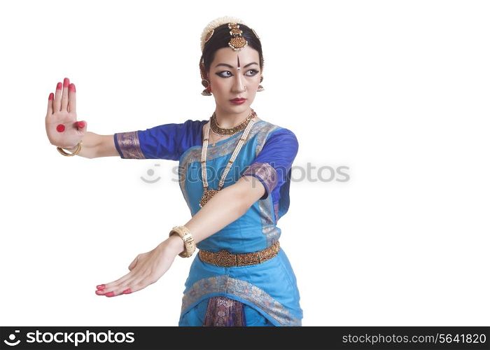 Beautiful dancer performing Bharatanatyam against white background