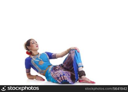 Beautiful dancer performing Bharatanatyam over white background