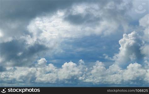 Beautiful dark clouds slowly flying in the sky. Wide photo.
