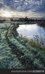 Beautiful dawn landscape of Priory ruins in countryside location