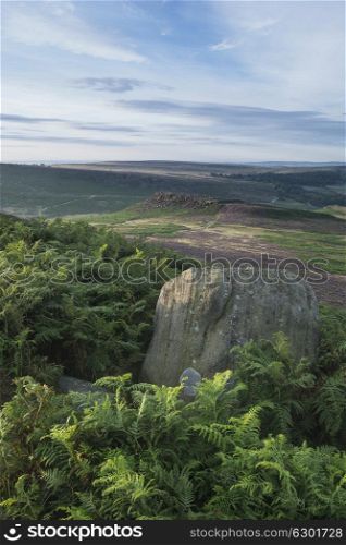 Beautiful dawn sunrise landscape image from Higger Tor towards Mother Cap in Summer in Peak District England