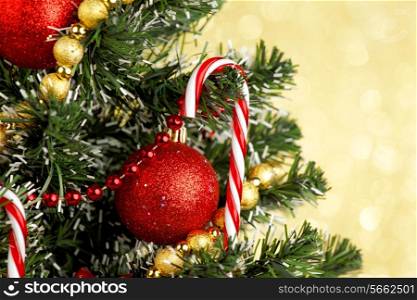 Beautiful decorated christmas tree on golden background