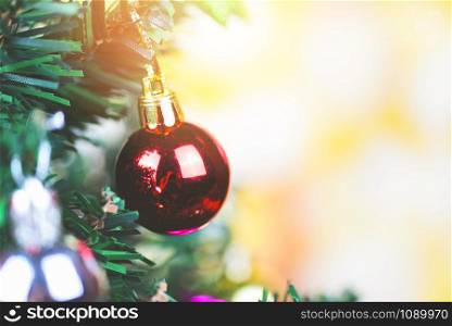 Beautiful decoration christmas tree on blurred colorful bokeh background / Christmas tree with ball and lights decorated pine tree New Year holidays festival celebration at home interior