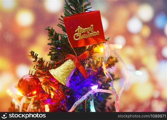 Beautiful decoration christmas tree on blurred colorful bokeh background / Christmas tree with ball gift box star and lights decorated pine tree New Year holidays festival celebration at home interior