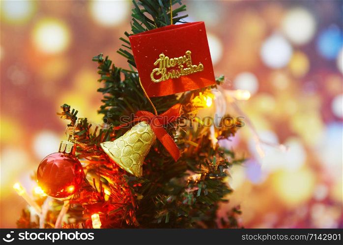 Beautiful decoration christmas tree on blurred colorful bokeh background / Christmas tree with ball gift box star and lights decorated pine tree New Year holidays festival celebration at home interior