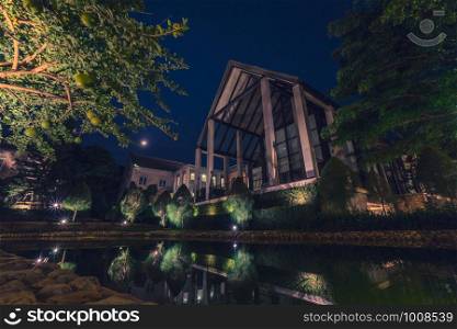 Beautiful decoration of English country style building covered with green creeper plant at night