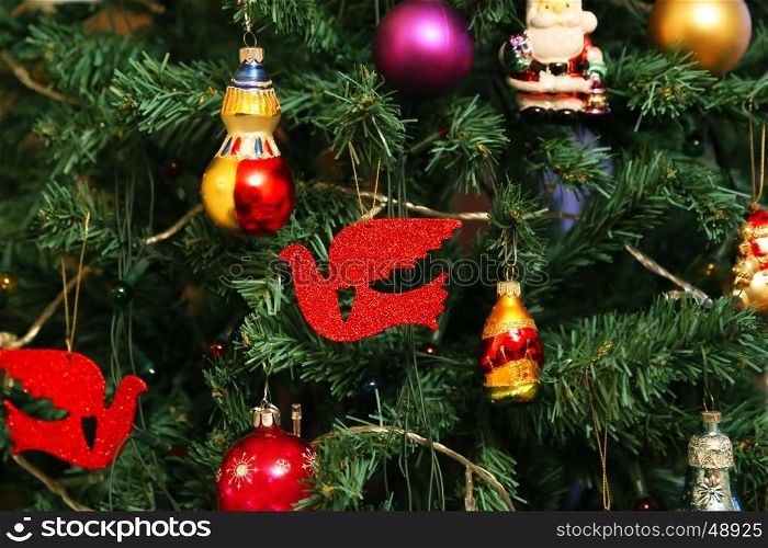 Beautiful decorations close up on faux Christmas tree