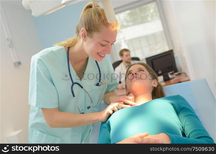 beautiful dermatologist inspecting patients skin in office