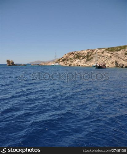 beautiful desert or uninhabited island in Greece with sailing/cruising boats