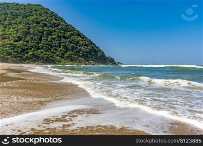 Beautiful deserted beach in Bertioga on the coast of Sao Paulo state, Brazil with the hill and rainforest in the background. Beautiful deserted beach in Bertioga on the coast of Sao Paulo state, Brazil
