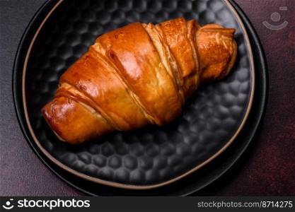 Beautiful different Christmas decorations and croissant on a brown concrete table. Preparation for New Year’s celebrations. Beautiful different Christmas decorations and croissant on a brown concrete table