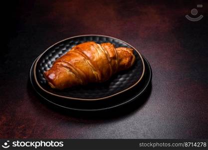 Beautiful different Christmas decorations and croissant on a brown concrete table. Preparation for New Year’s celebrations. Beautiful different Christmas decorations and croissant on a brown concrete table