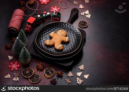 Beautiful different Christmas decorations and gingerbread on a brown concrete table. Preparation for New Year&rsquo;s celebrations. Beautiful different Christmas decorations and gingerbread on a brown concrete table
