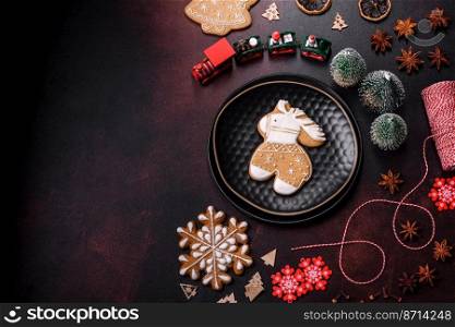 Beautiful different Christmas decorations and gingerbread on a brown concrete table. Preparation for New Year’s celebrations. Beautiful different Christmas decorations and gingerbread on a brown concrete table