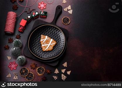 Beautiful different Christmas decorations and gingerbread on a brown concrete table. Preparation for New Year’s celebrations. Beautiful different Christmas decorations and gingerbread on a brown concrete table