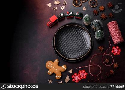 Beautiful different Christmas decorations and gingerbread on a brown concrete table. Preparation for New Year&rsquo;s celebrations. Beautiful different Christmas decorations and gingerbread on a brown concrete table