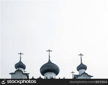 Beautiful domes of the Spaso-Preobrazhensky Solovetsky monastery on the sky background.