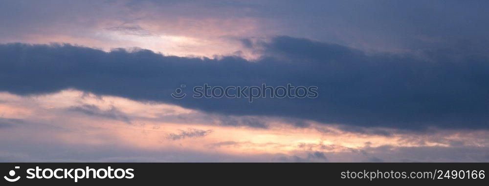 Beautiful dramatic evening sky in blue, yellow and orange colors. Sunset sky. Long banner. Beautiful dramatic evening sky in blue, yellow and orange colors. Sunset sky. Long banner.