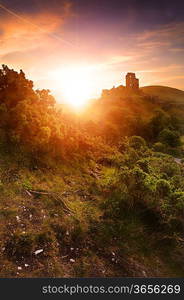 Beautiful dreamy fairytale castle ruins against romantic colorful sunrise