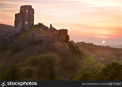 Beautiful dreamy fairytale castle ruins against romantic colorful sunrise