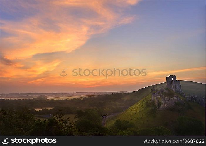 Beautiful dreamy fairytale castle ruins against romantic colorful sunrise
